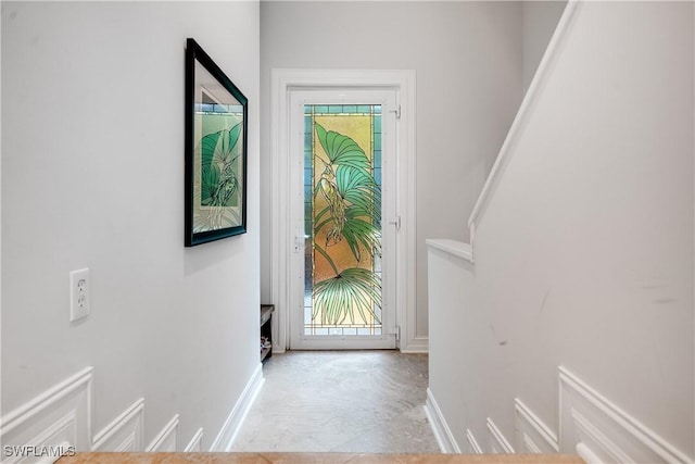 doorway featuring baseboards