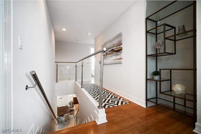 stairway with hardwood / wood-style floors