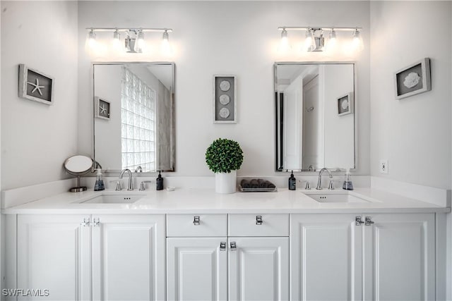 bathroom featuring a sink and double vanity