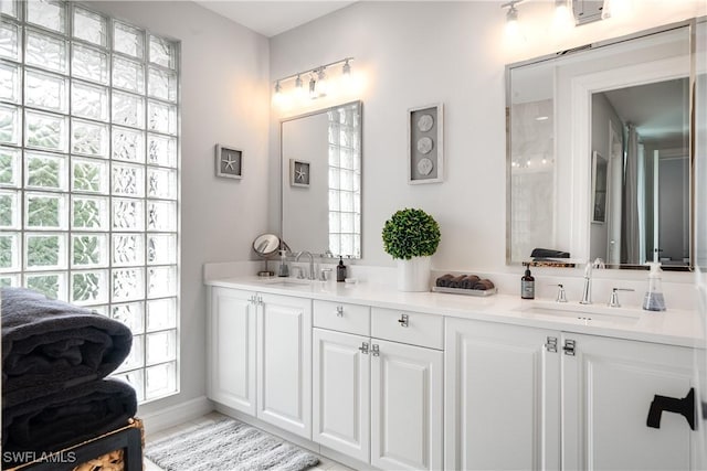 full bath featuring double vanity and a sink