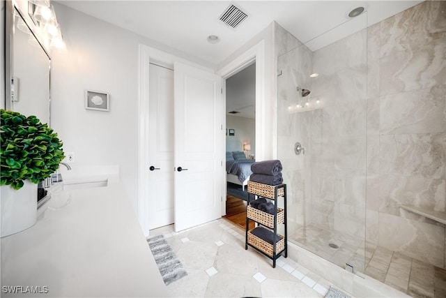 bathroom with visible vents, ensuite bathroom, a sink, a tile shower, and double vanity