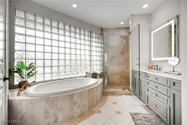 bathroom with vanity, tile patterned floors, and independent shower and bath