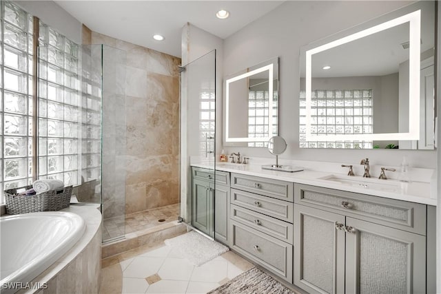 bathroom with tile patterned floors, a walk in shower, a sink, double vanity, and a bath