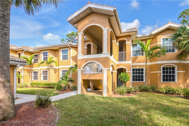 mediterranean / spanish-style house with a front lawn