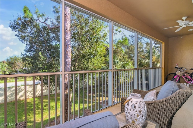 sunroom with a wealth of natural light and ceiling fan