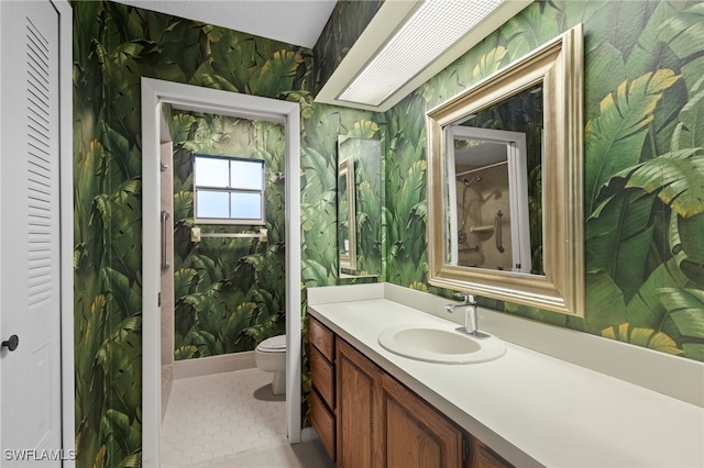 bathroom featuring toilet, vanity, and tile patterned floors