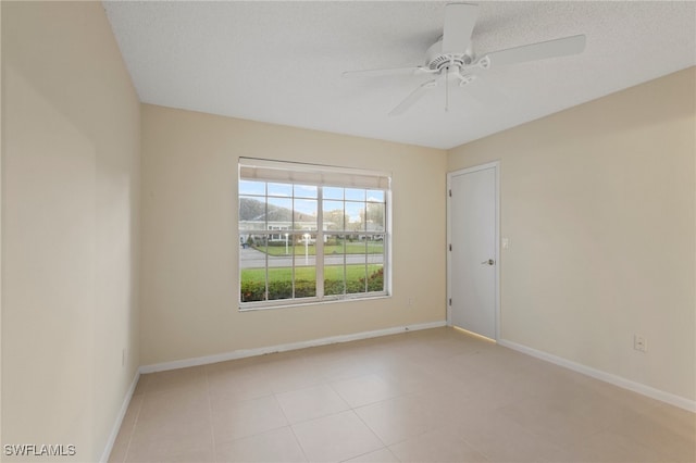 empty room featuring ceiling fan and a textured ceiling