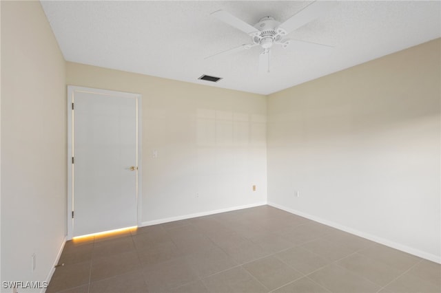 spare room featuring a textured ceiling and ceiling fan