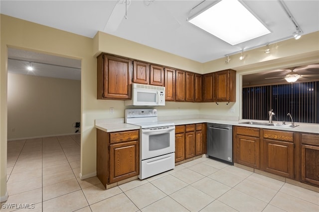 kitchen featuring light tile patterned flooring, sink, rail lighting, white appliances, and ceiling fan