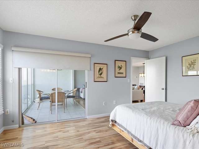 bedroom featuring a textured ceiling, access to outside, light hardwood / wood-style floors, and ceiling fan