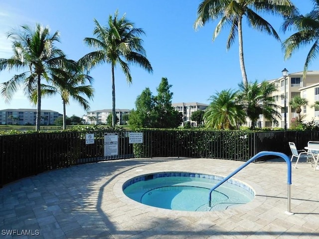 view of swimming pool with a patio area and a hot tub