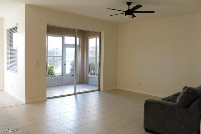 unfurnished room with ceiling fan and light tile patterned floors