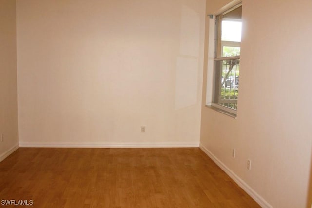 empty room with hardwood / wood-style floors