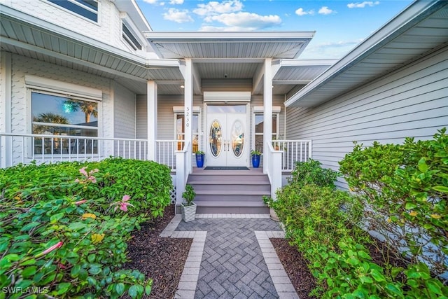 view of exterior entry with a porch