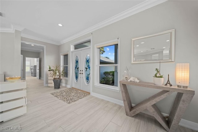 entrance foyer featuring french doors, light wood-type flooring, and ornamental molding