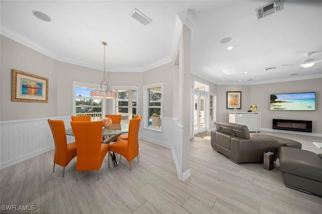 dining area featuring light hardwood / wood-style floors and ornamental molding