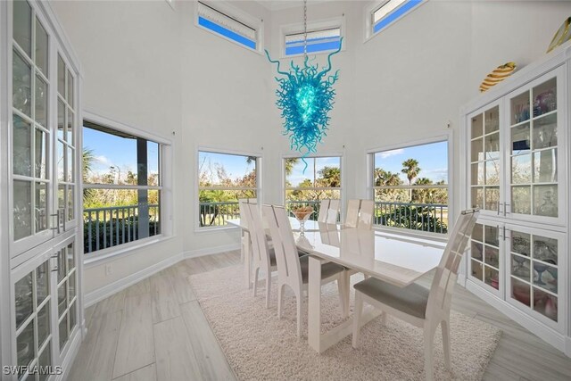 sunroom / solarium with plenty of natural light and a chandelier