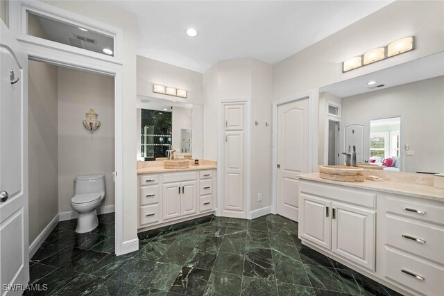 bathroom featuring vanity and toilet