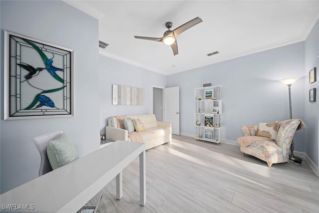 living room featuring ceiling fan, ornamental molding, and light hardwood / wood-style flooring