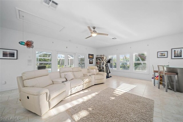 tiled living room with ceiling fan