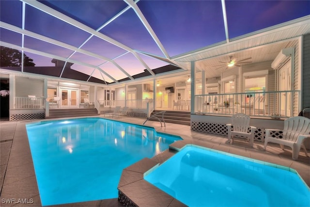 view of swimming pool with ceiling fan, a lanai, a patio, and a wooden deck