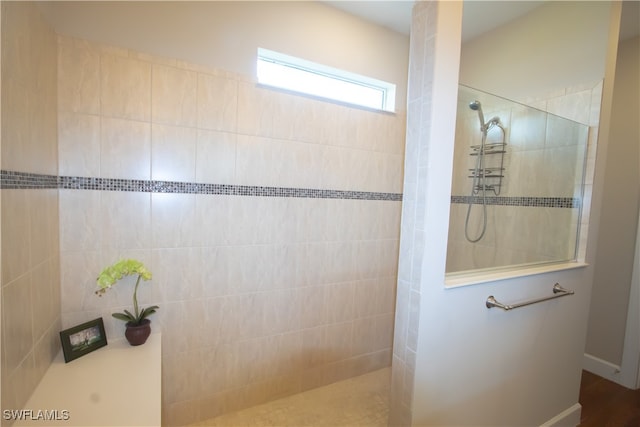 bathroom with a tile shower