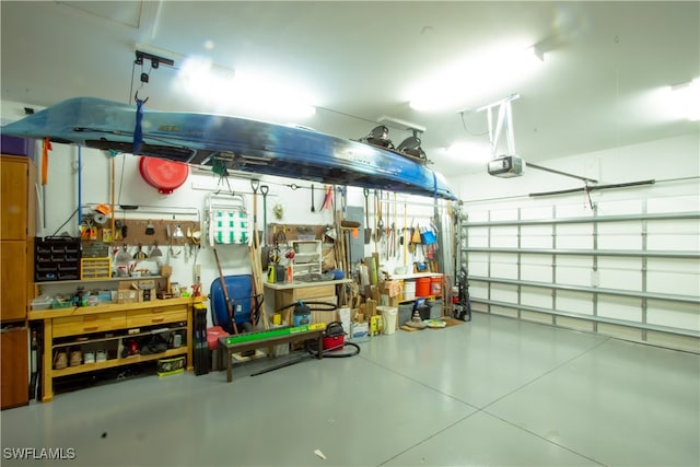 garage with a garage door opener and a workshop area