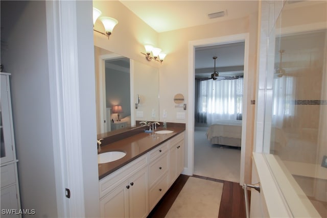 bathroom featuring vanity and tiled shower