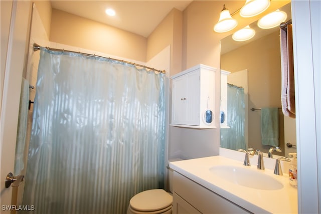 bathroom featuring vanity, a shower with curtain, and toilet