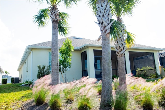 view of front of property featuring cooling unit and a sunroom