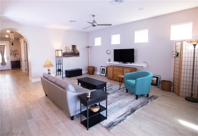 living room featuring light hardwood / wood-style floors and ceiling fan