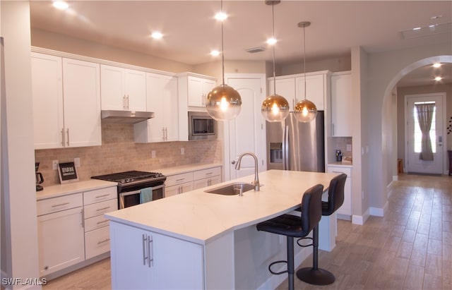 kitchen with sink, white cabinets, and stainless steel appliances