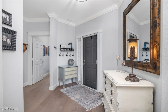 foyer featuring ornamental molding and light wood-type flooring