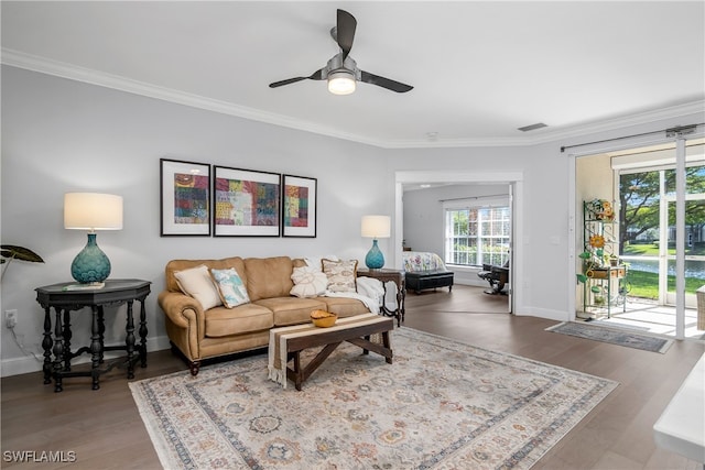 living room featuring crown molding, ceiling fan, and wood-type flooring