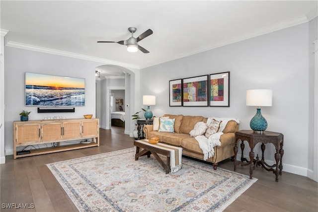 living room with crown molding, dark hardwood / wood-style flooring, and ceiling fan