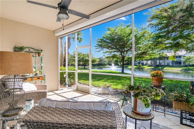 sunroom / solarium featuring a water view and ceiling fan