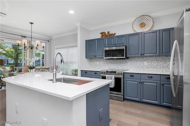 kitchen featuring a center island with sink, a wealth of natural light, and appliances with stainless steel finishes