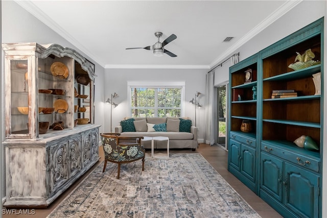 sitting room with crown molding, ceiling fan, and wood-type flooring