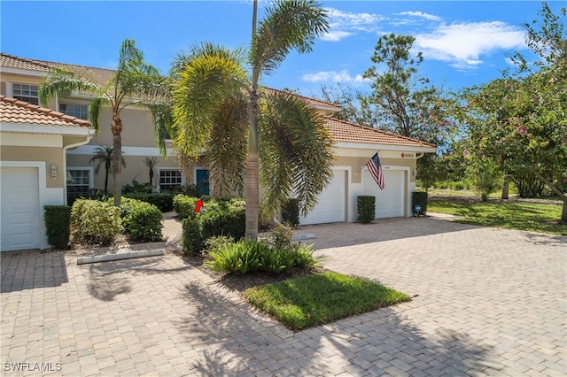 mediterranean / spanish home with a garage