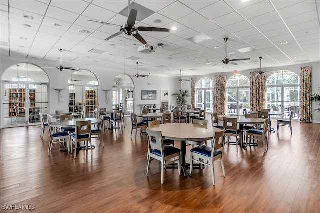 dining space featuring a paneled ceiling, ceiling fan, and wood-type flooring