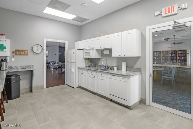 kitchen with white cabinets, white appliances, ceiling fan, and sink