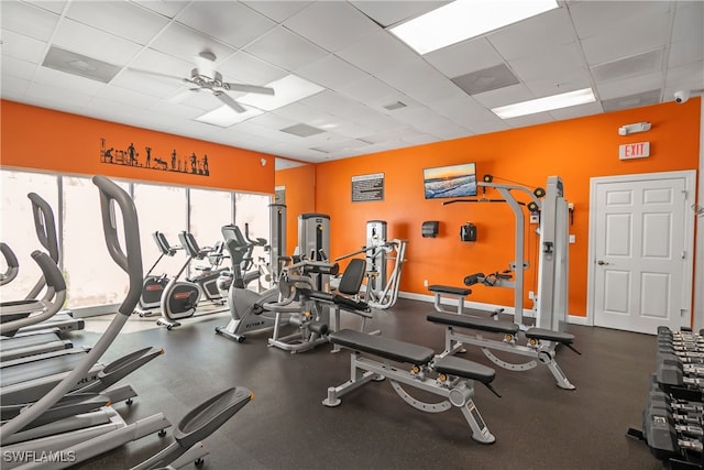 workout area with a drop ceiling and ceiling fan