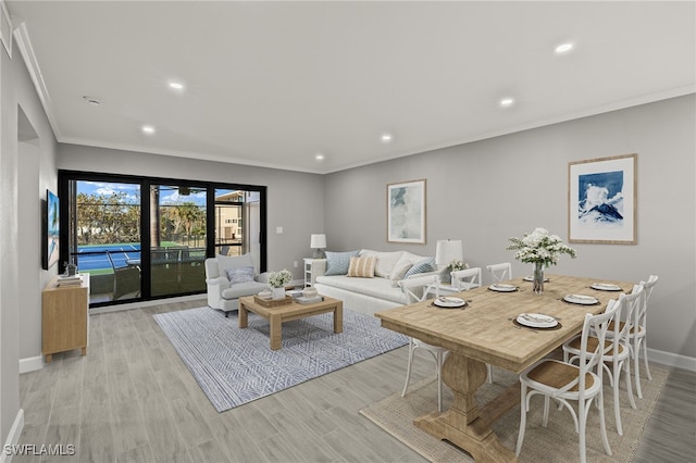 living room featuring light hardwood / wood-style floors and ornamental molding