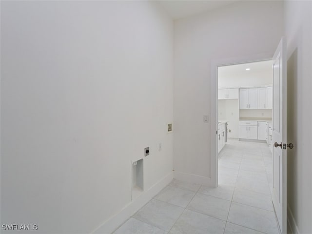 washroom with hookup for a washing machine, electric dryer hookup, and light tile patterned floors