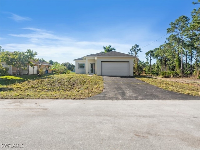 single story home with a front yard and a garage