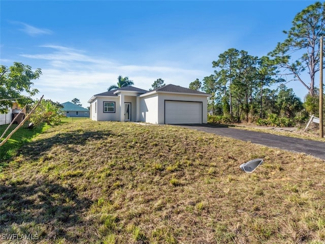 ranch-style house with a front yard and a garage