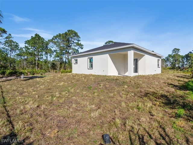 back of house with a lawn