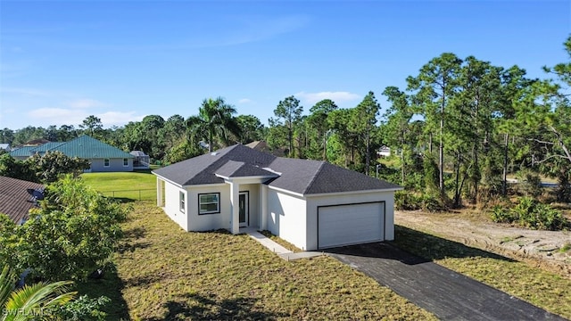 view of front of house featuring a front yard and a garage