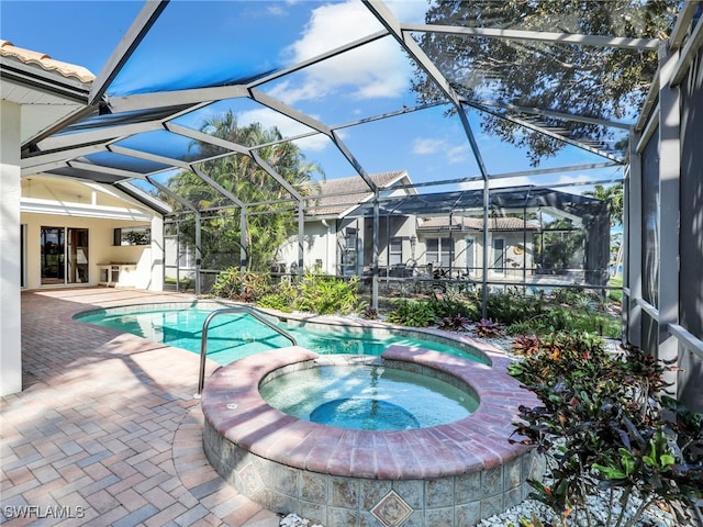 view of swimming pool featuring an in ground hot tub, a patio, and glass enclosure