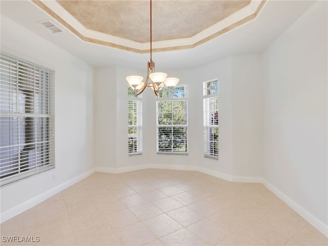 empty room with ornamental molding, light tile patterned flooring, a notable chandelier, and a tray ceiling